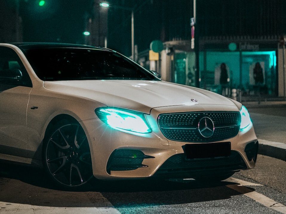 silver mercedes coupe on road during night time
