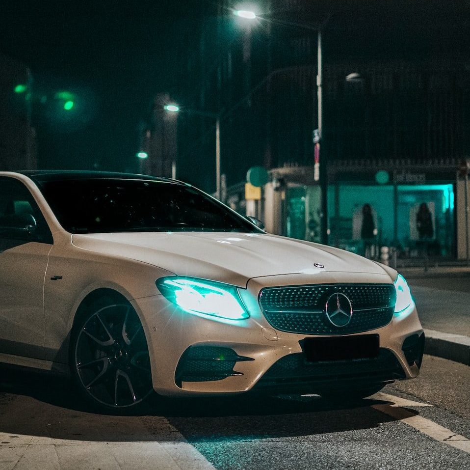 silver mercedes coupe on road during night time